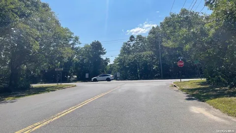 a backyard of a house with trees and outdoor seating