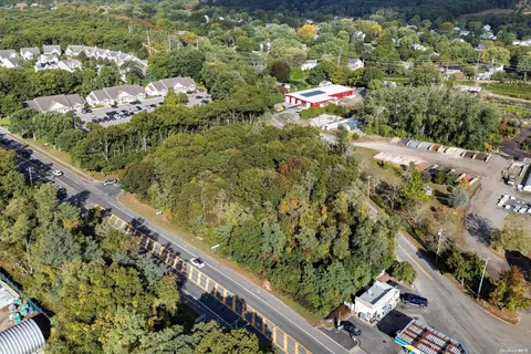an aerial view of a houses with a yard