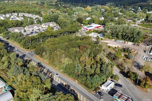 an aerial view of a houses with a yard