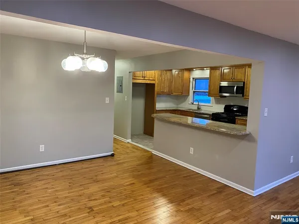 a kitchen with stainless steel appliances granite countertop a sink and a stove