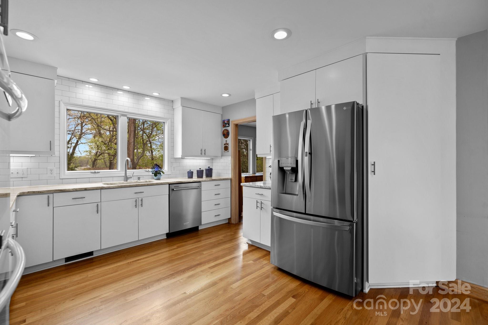 4500 Rounding Run Road Charlotte, NC 28277 - Photo 14 of 41 a kitchen with a refrigerator a sink and cabinets