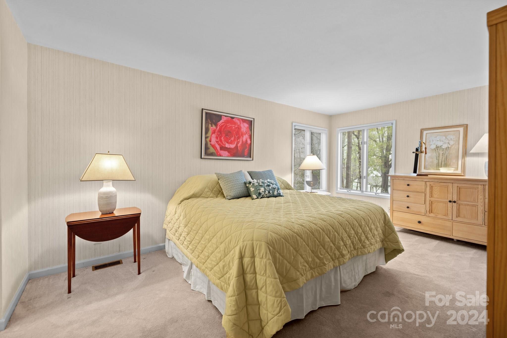 4500 Rounding Run Road Charlotte, NC 28277 - Photo 24 of 41 a spacious bedroom with a bed and a lamp on dresser