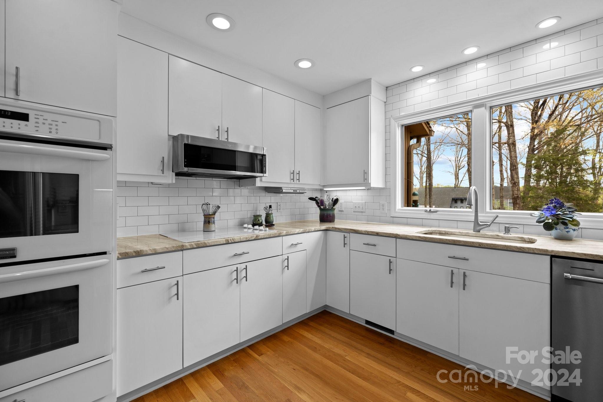 4500 Rounding Run Road Charlotte, NC 28277 - Photo 5 of 41 a kitchen with a sink window and cabinets