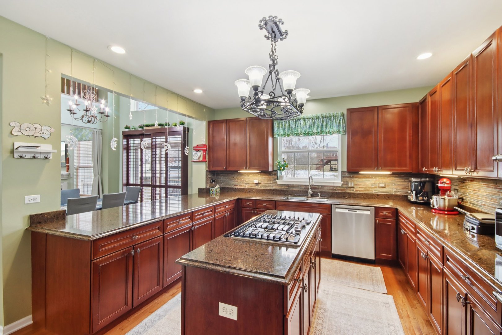 2930 Kelly Drive Elgin, IL 60124 - Photo 11 of 45 a kitchen with stainless steel appliances granite countertop a stove top oven a sink dishwasher and cabinets with wooden floor