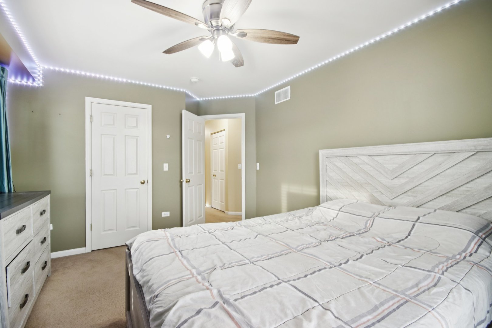 2930 Kelly Drive Elgin, IL 60124 - Photo 32 of 45 a bedroom with a large bed and a chandelier