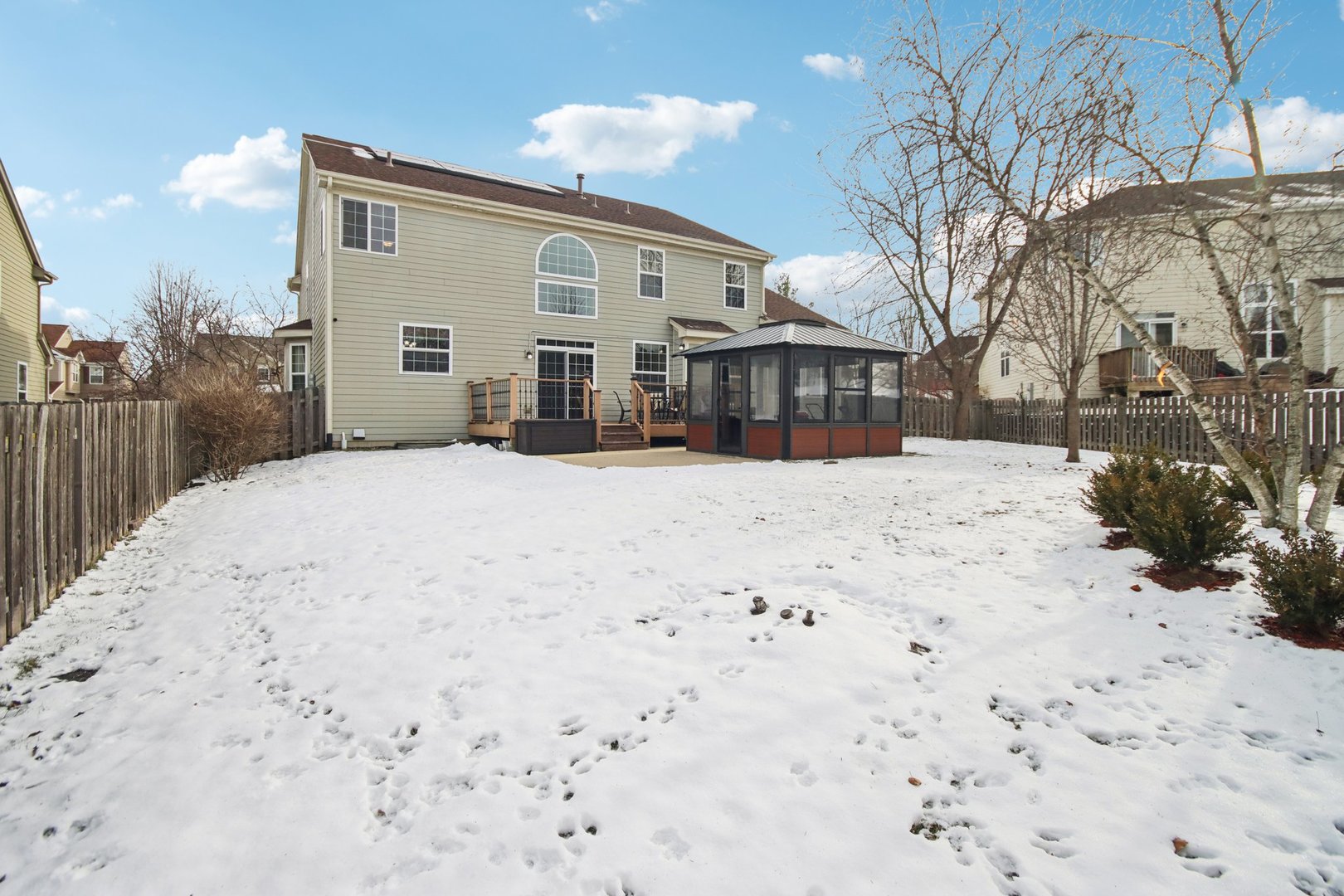 2930 Kelly Drive Elgin, IL 60124 - Photo 40 of 45 a view of large white house with a snow in the yard