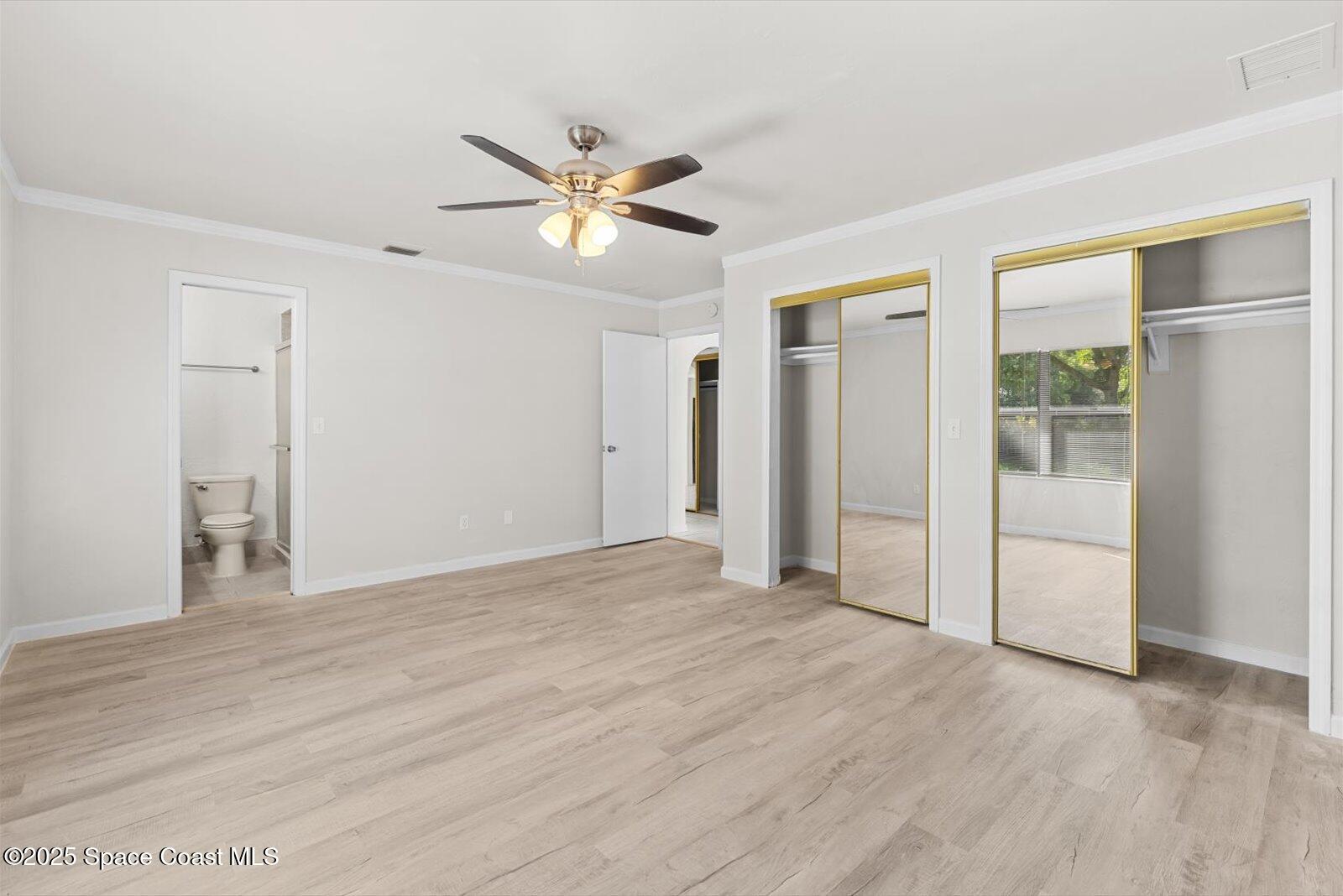 402 Southwest Sansom Lane Port St. Lucie, FL 34953 - Photo 13 of 33 a view of an empty room with wooden floor and a window