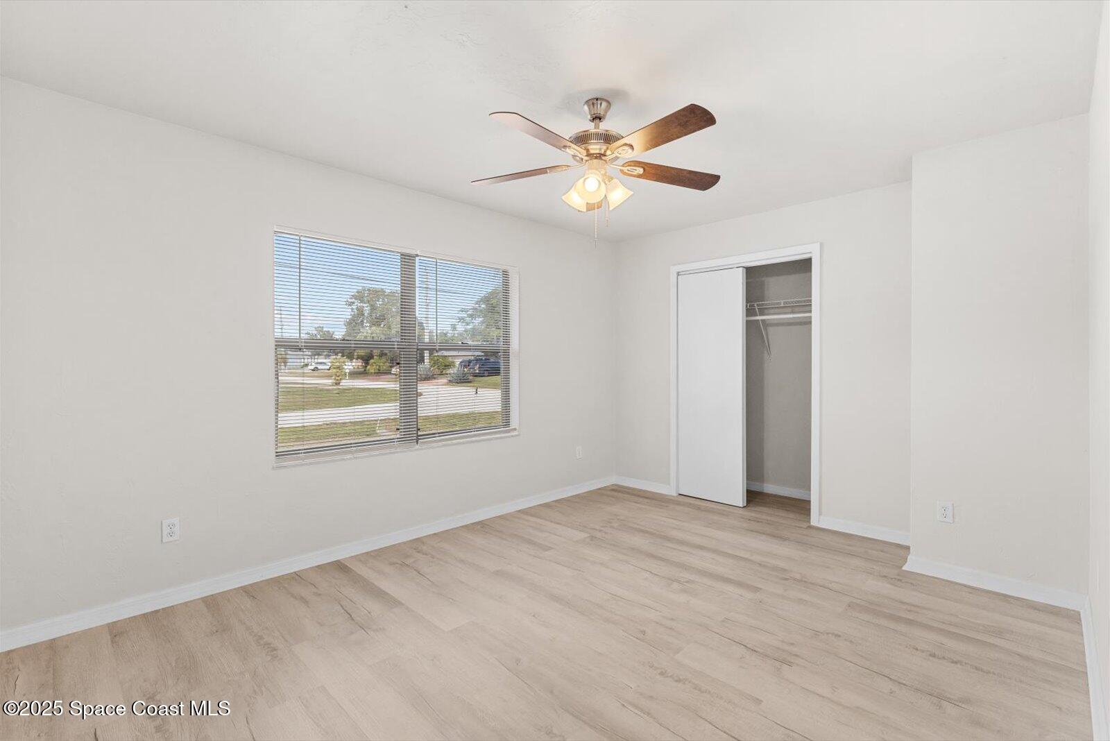 402 Southwest Sansom Lane Port St. Lucie, FL 34953 - Photo 17 of 33 a view of a big room with wooden floor and windows in a room