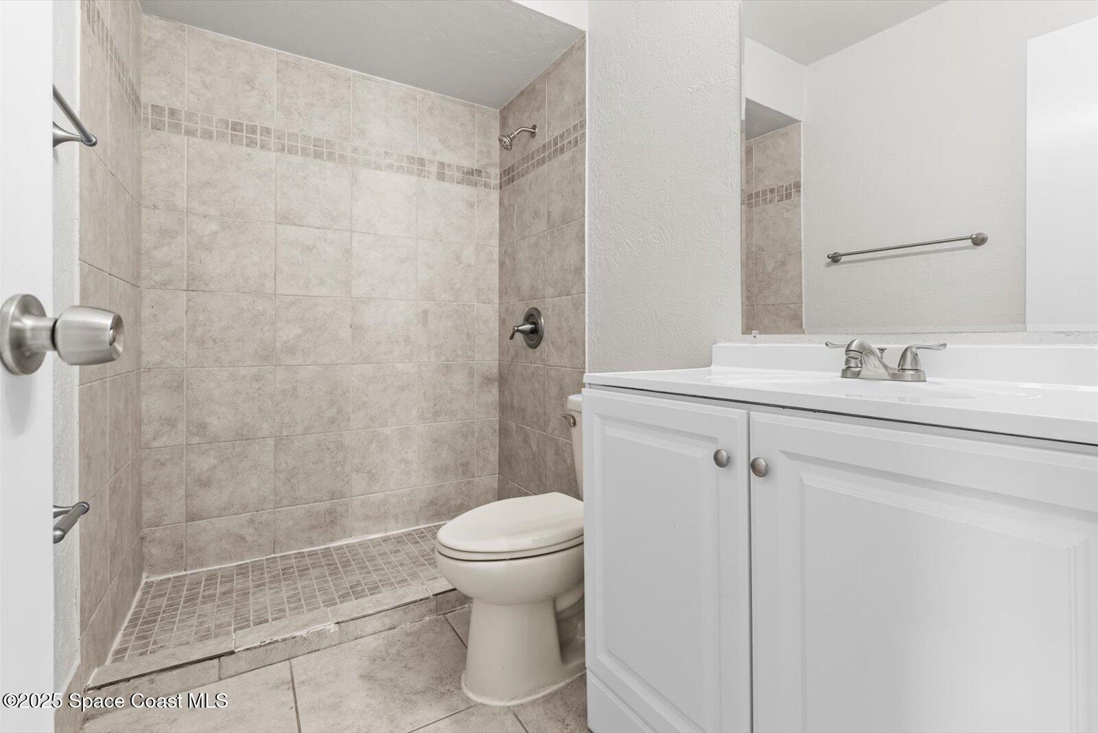 402 Southwest Sansom Lane Port St. Lucie, FL 34953 - Photo 19 of 33 a bathroom with a sink toilet and shower