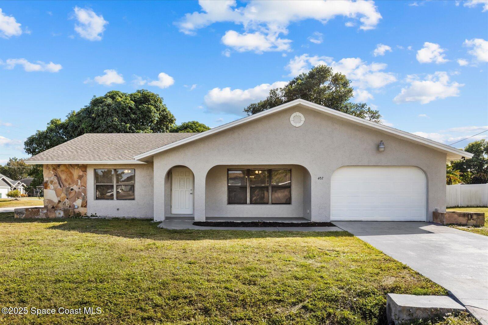 402 Southwest Sansom Lane Port St. Lucie, FL 34953 - Photo 2 of 33 a front view of house with yard