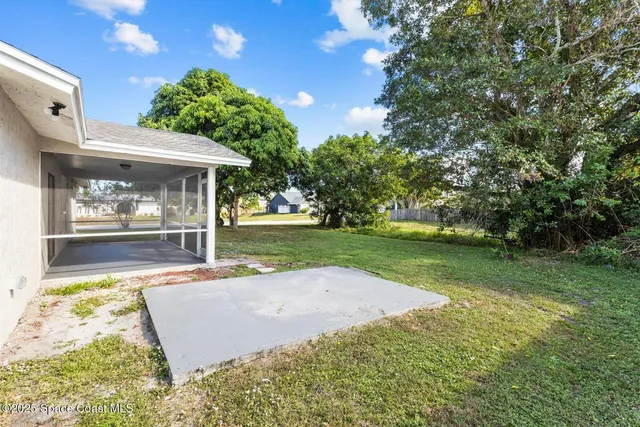 a view of a house with yard and a garden