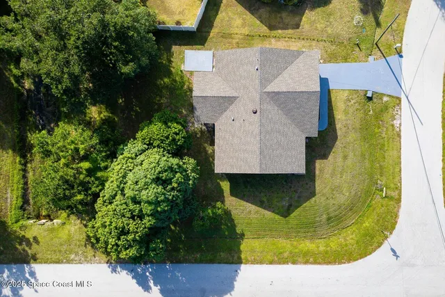a aerial view of a house with a garden and plants