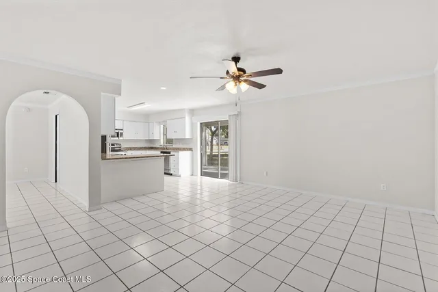 a view of kitchen with refrigerator cabinets and window