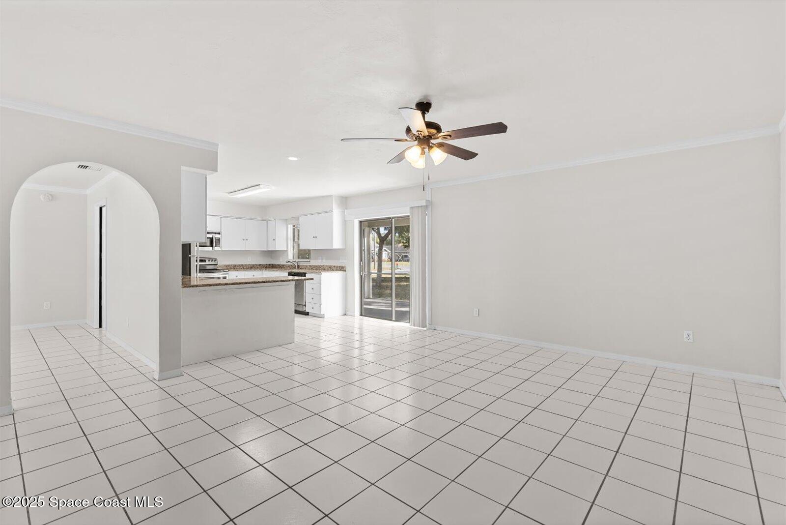 402 Southwest Sansom Lane Port St. Lucie, FL 34953 - Photo 7 of 33 a view of kitchen with refrigerator cabinets and window