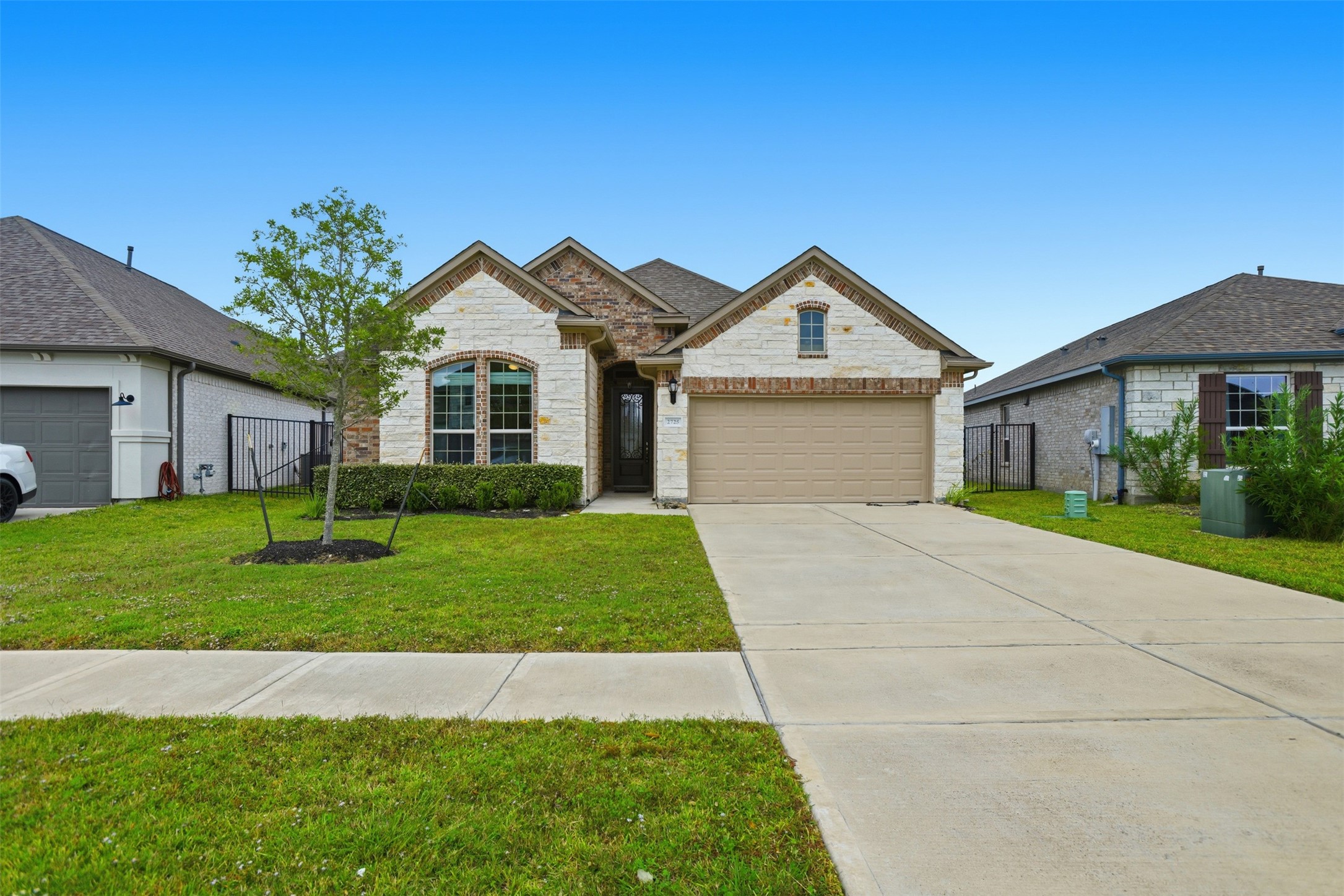 2725 Arbor Edge Crossing La Marque, TX 77568 - Photo 1 of 38 a front view of a house with a yard and garage