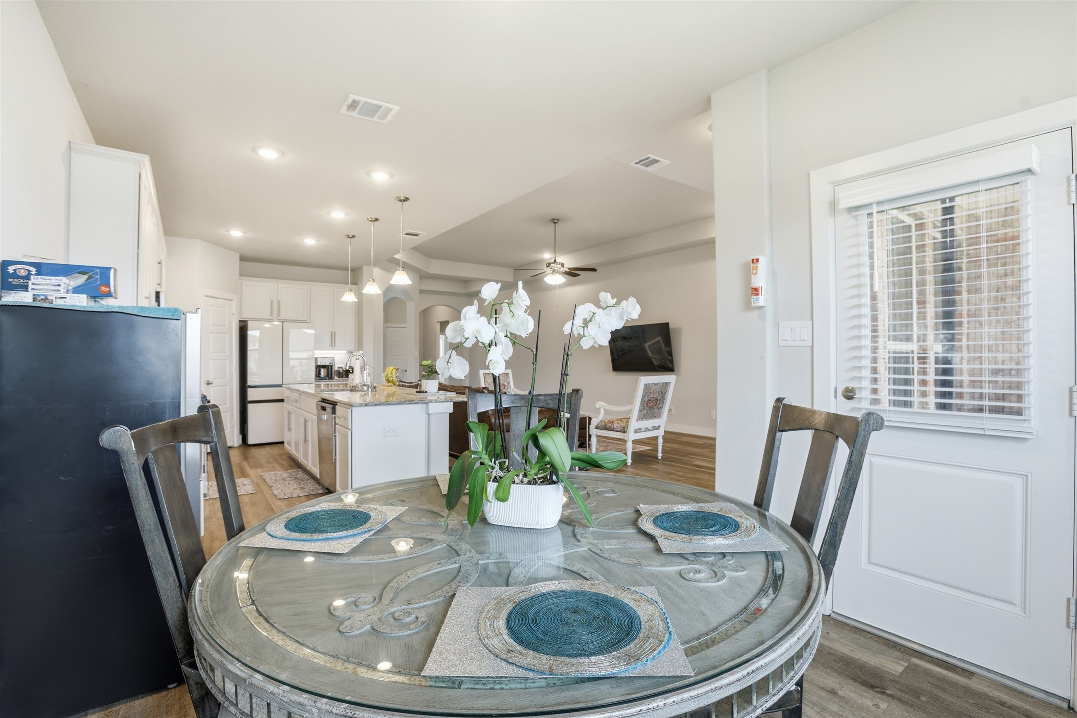 2725 Arbor Edge Crossing La Marque, TX 77568 - Photo 15 of 38 a dining room with furniture a large window and wooden floor