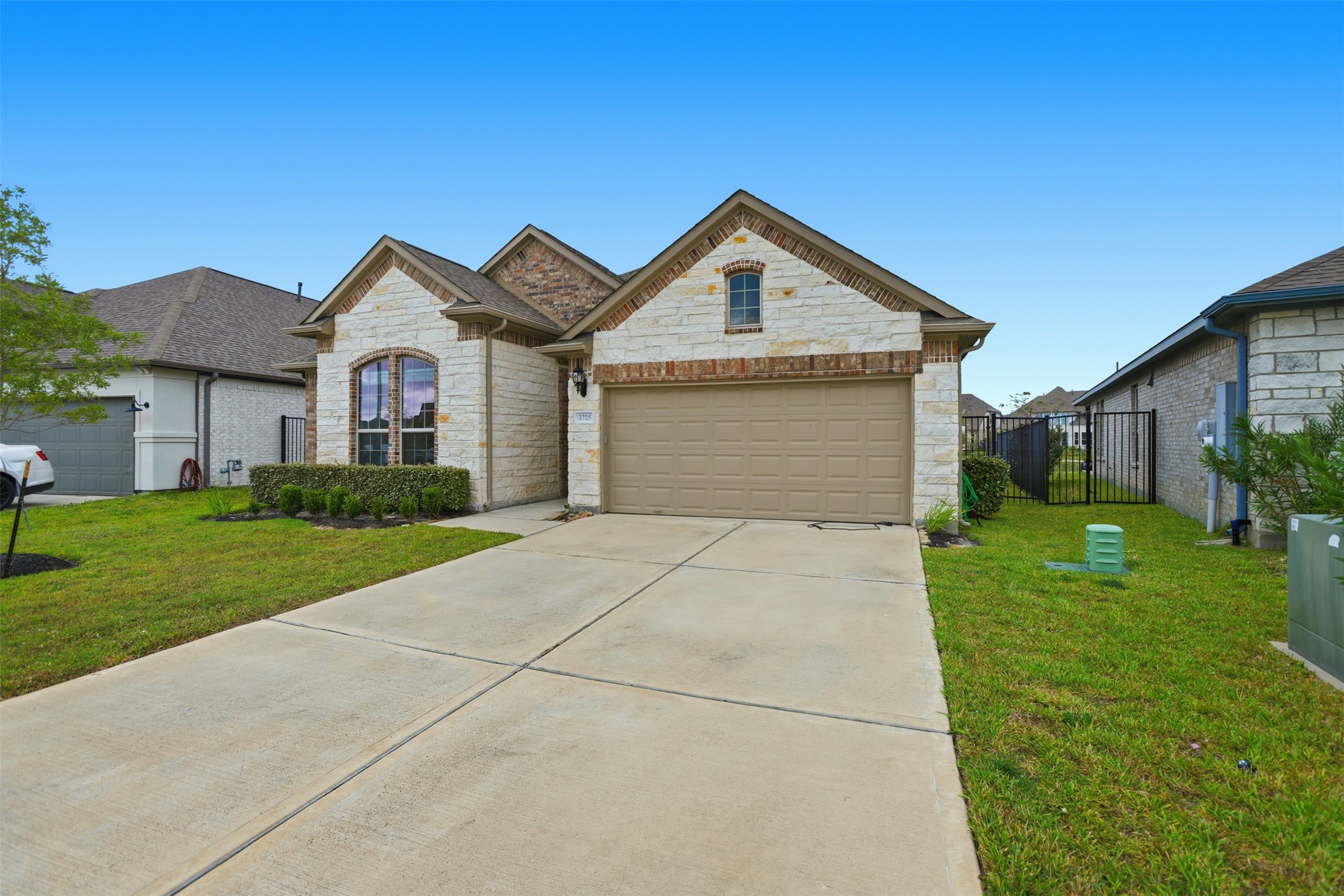 2725 Arbor Edge Crossing La Marque, TX 77568 - Photo 2 of 38 a front view of a house with a yard and garage