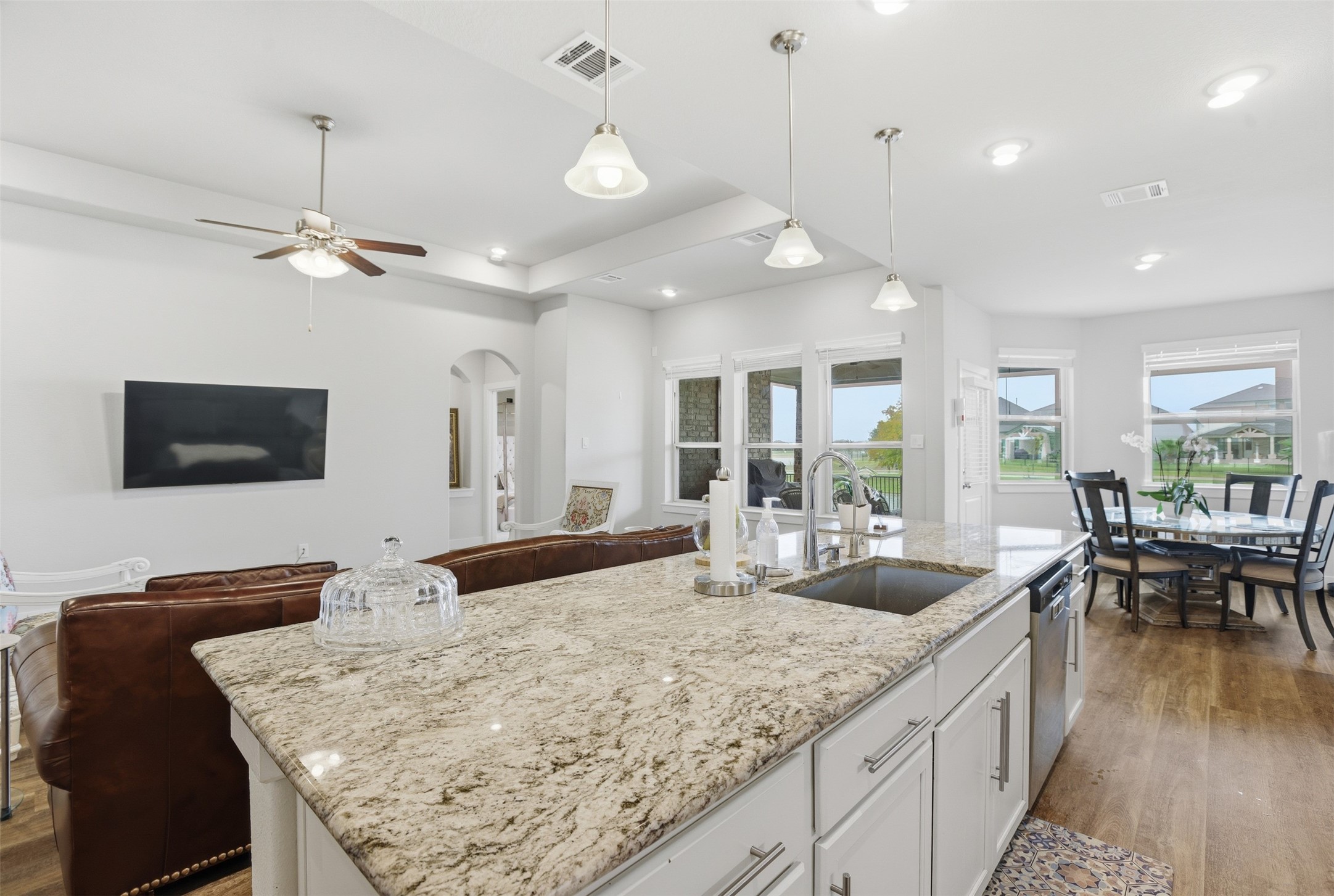 2725 Arbor Edge Crossing La Marque, TX 77568 - Photo 10 of 38 a kitchen with granite countertop a sink a counter top space and living room view