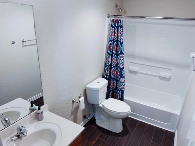 a white toilet sitting next to a bathroom sink