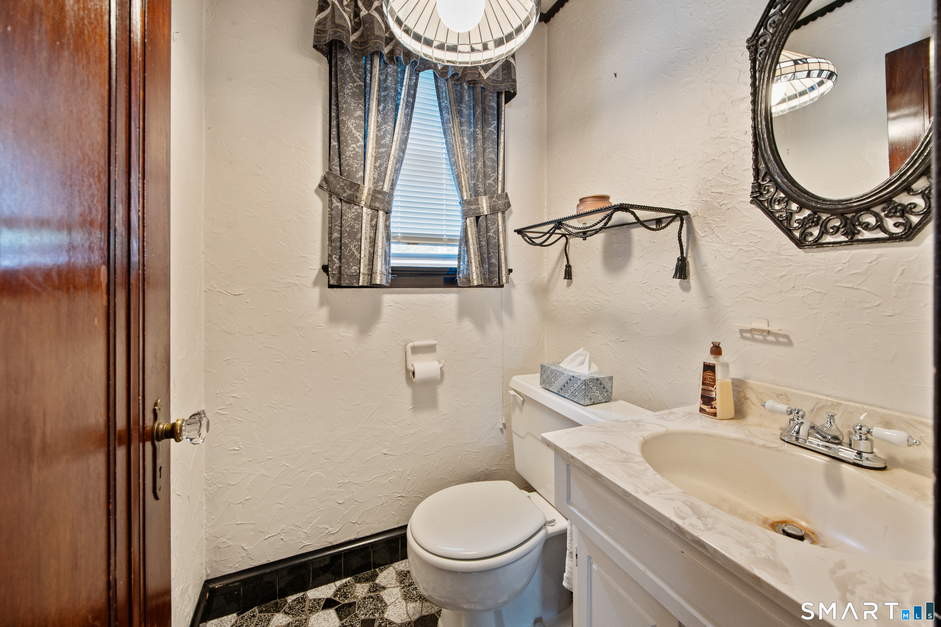 90 Harvard Avenue Meriden, CT 06451 - Photo 14 of 39 a bathroom with a toilet a sink and a mirror