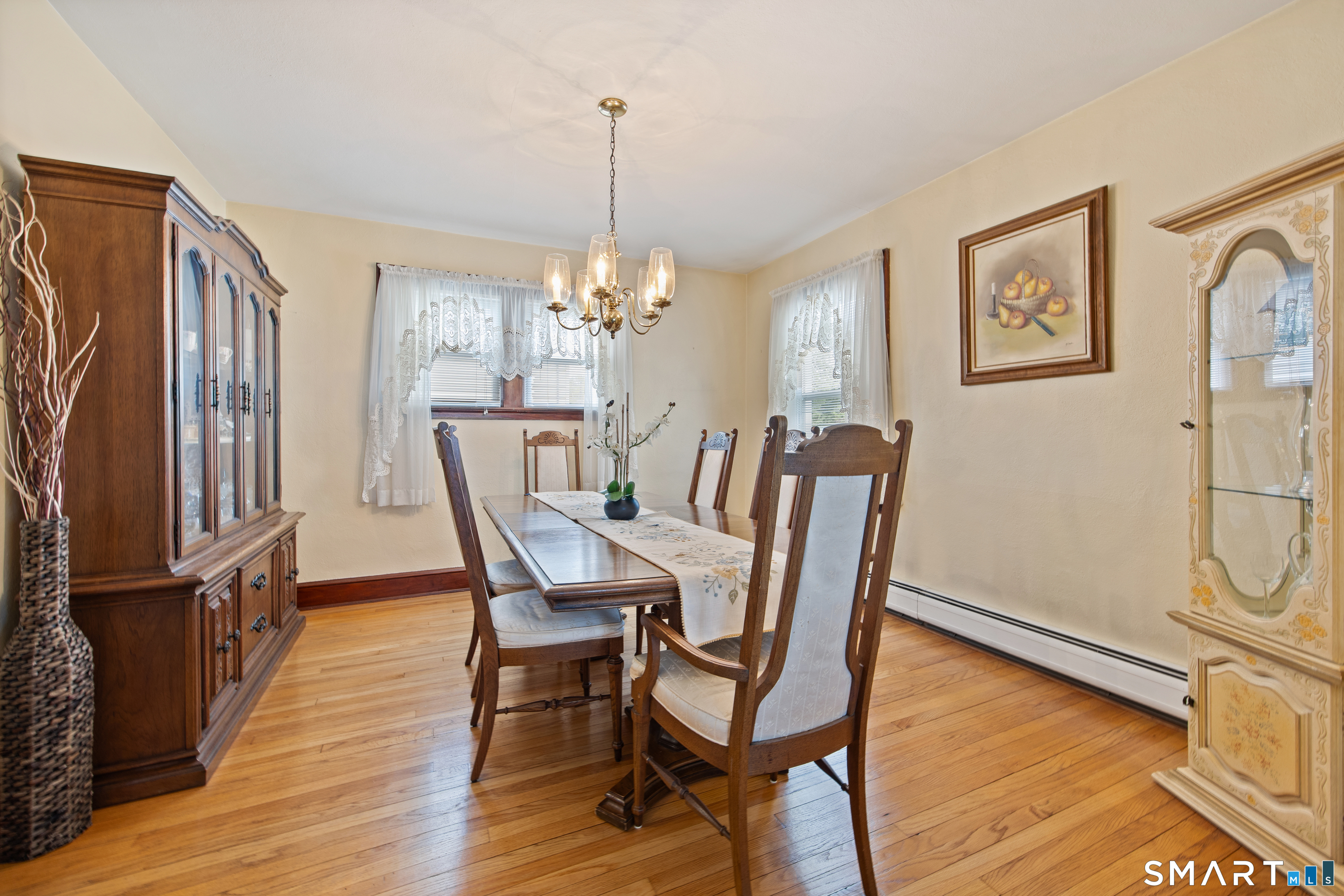 90 Harvard Avenue Meriden, CT 06451 - Photo 19 of 39 a dining room with furniture a chandelier and wooden floor
