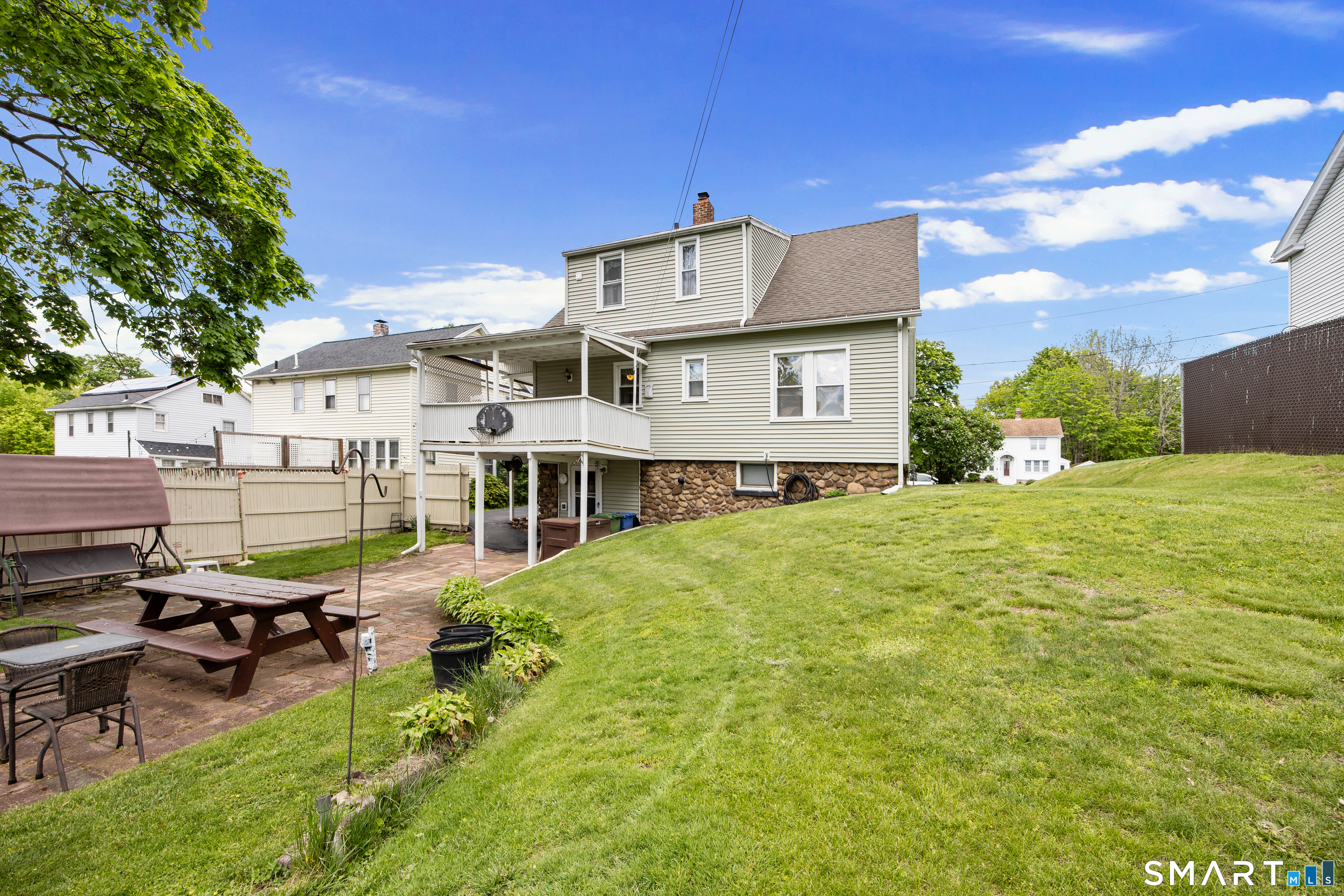 90 Harvard Avenue Meriden, CT 06451 - Photo 2 of 39 a backyard of a house with table and chairs