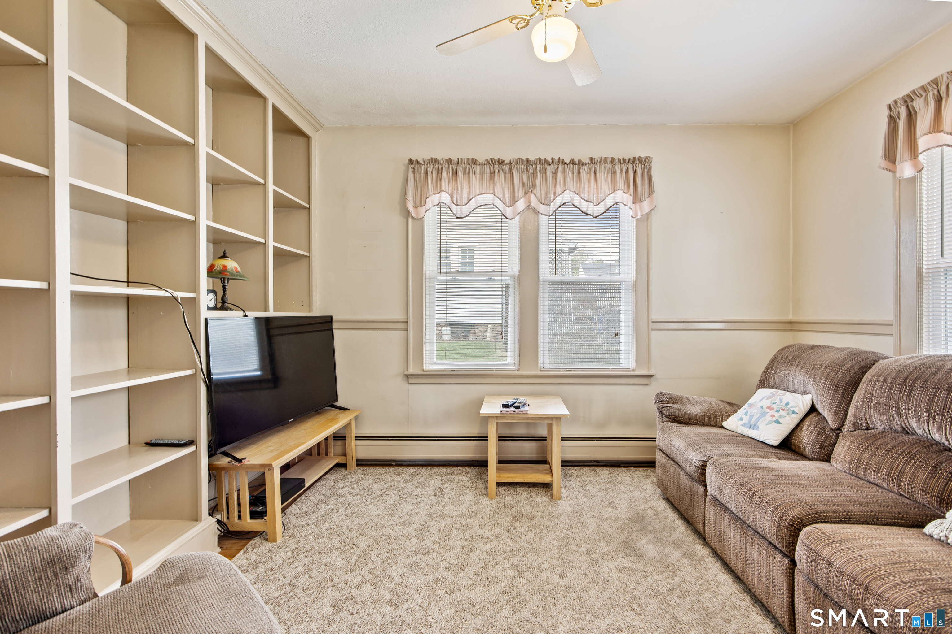 90 Harvard Avenue Meriden, CT 06451 - Photo 24 of 39 a living room with furniture and a flat screen tv