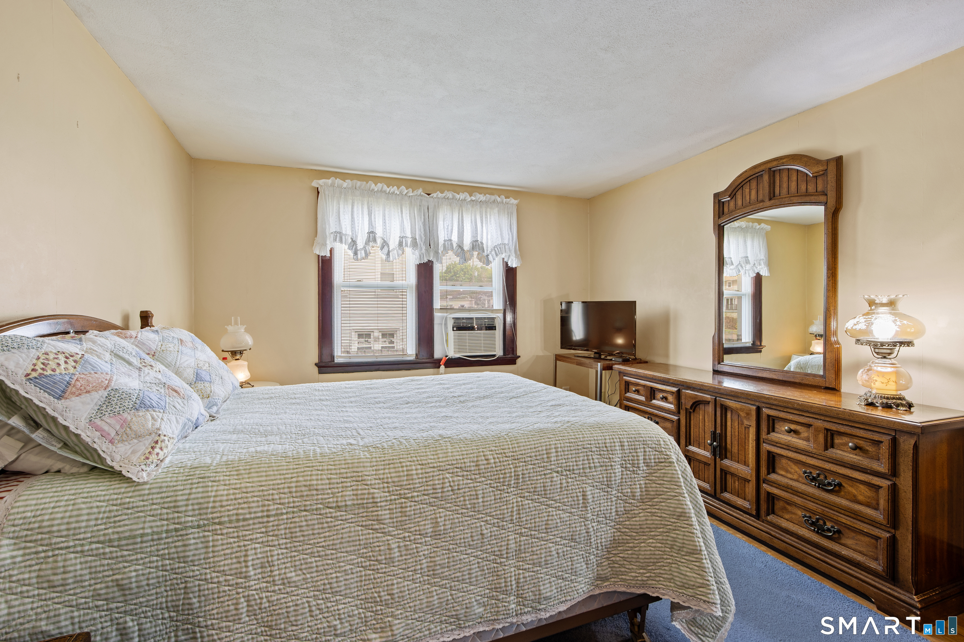 90 Harvard Avenue Meriden, CT 06451 - Photo 30 of 39 a bedroom with a large bed and a dresser