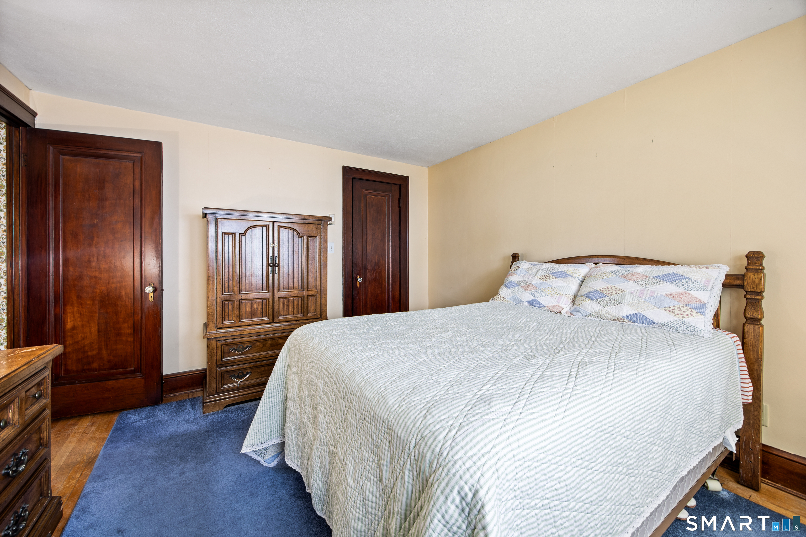 90 Harvard Avenue Meriden, CT 06451 - Photo 31 of 39 a bedroom with a bed and wooden floor