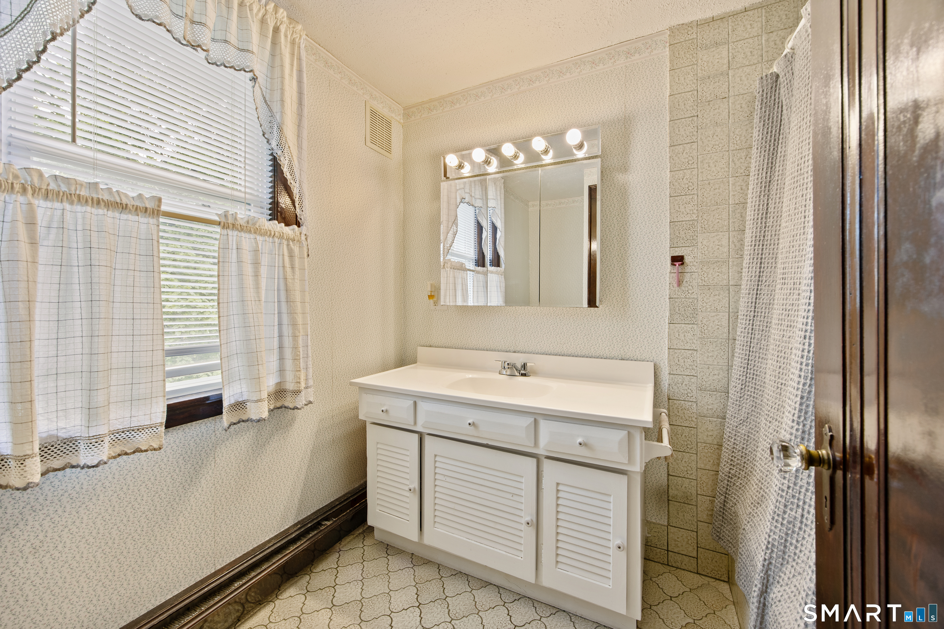 90 Harvard Avenue Meriden, CT 06451 - Photo 34 of 39 a bathroom with a double vanity sink a mirror and a shower