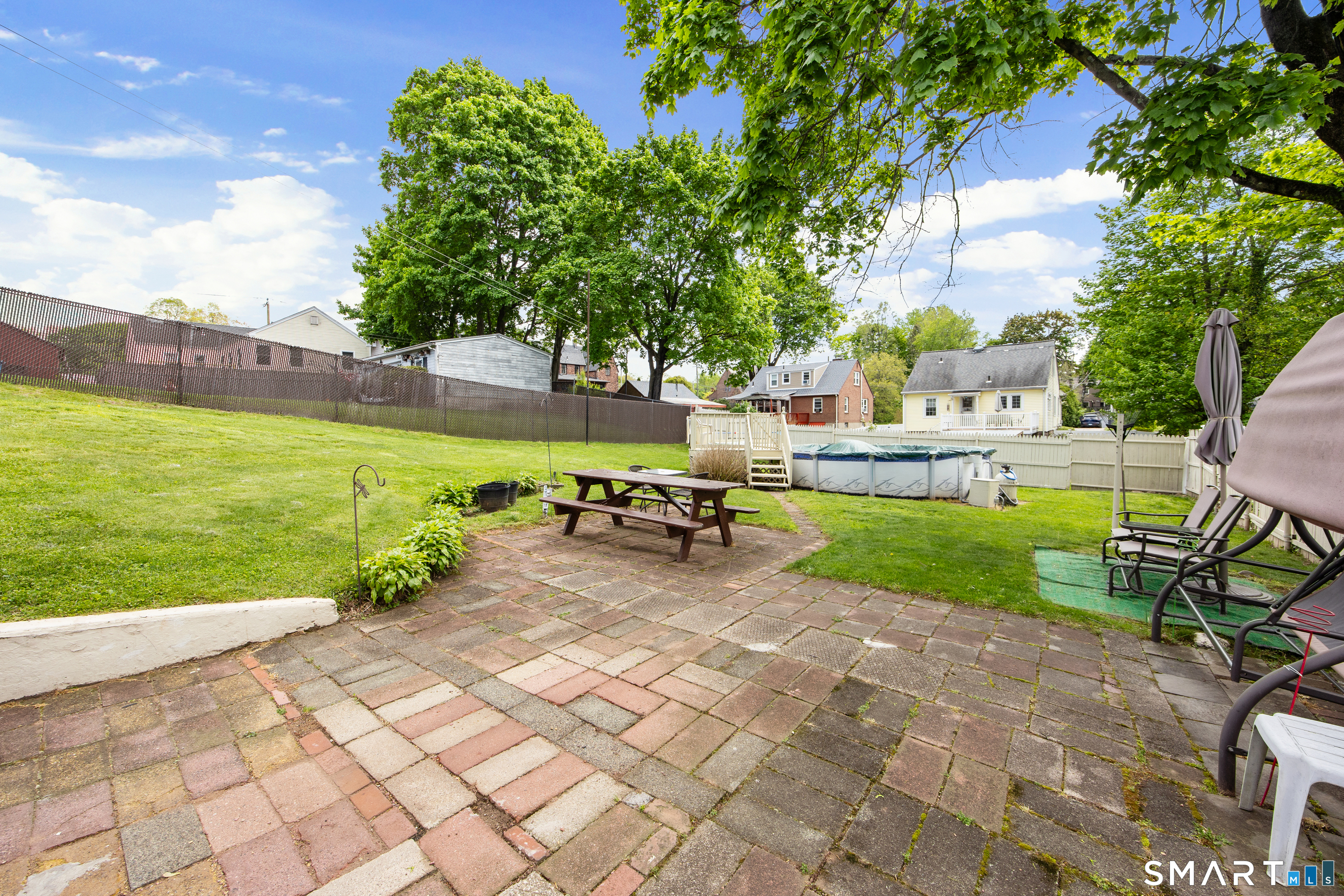 90 Harvard Avenue Meriden, CT 06451 - Photo 5 of 39 a view of a garden with lawn chairs and a fire pit