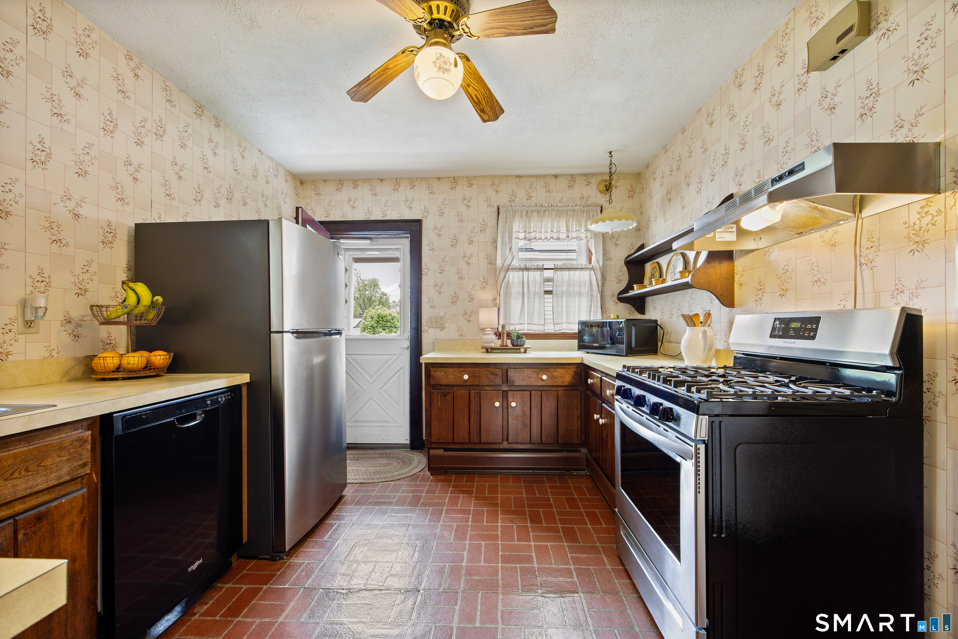 90 Harvard Avenue Meriden, CT 06451 - Photo 9 of 39 a kitchen with a stove top oven and refrigerator