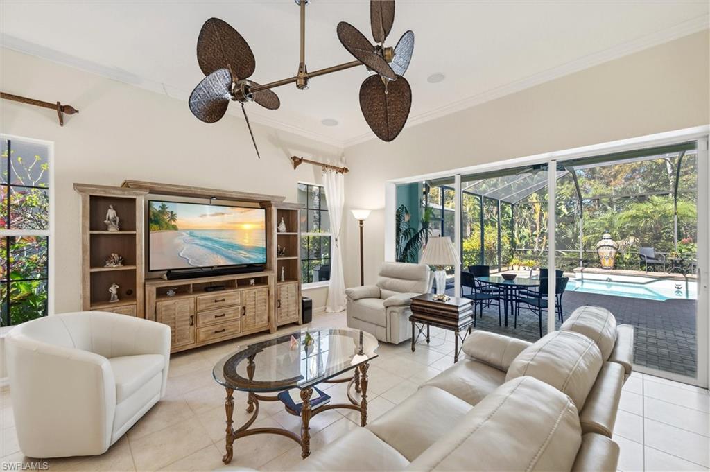 3033 Olde Cove Way Naples, FL 34119 - Photo 16 of 49 Spacious family room with view of lanai and pool area