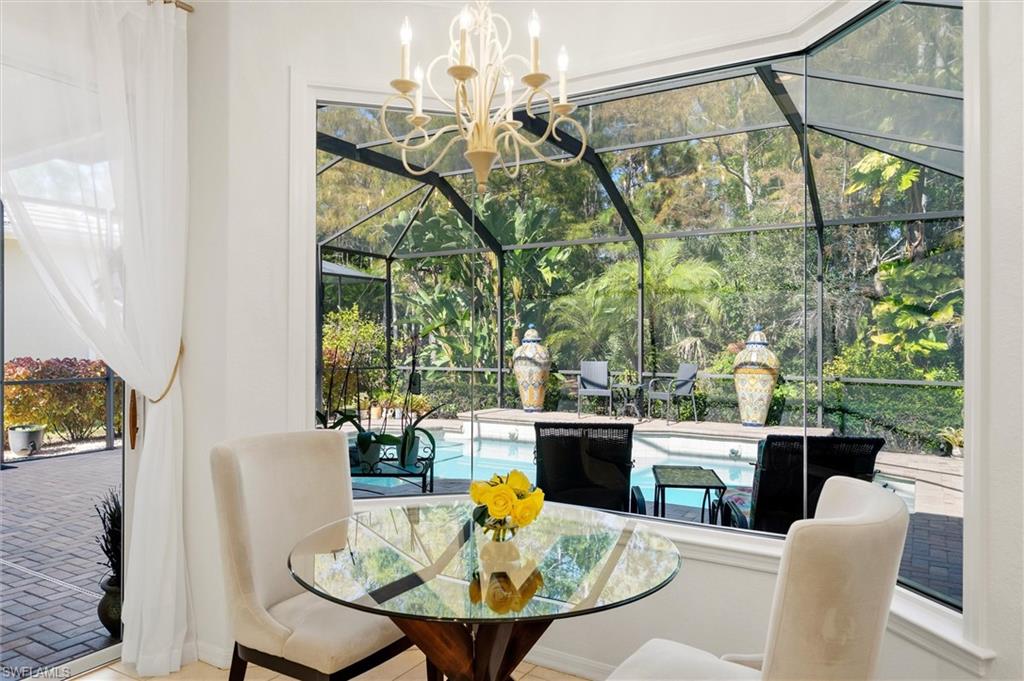 3033 Olde Cove Way Naples, FL 34119 - Photo 19 of 49 Breakfast area with view of pool and lanai