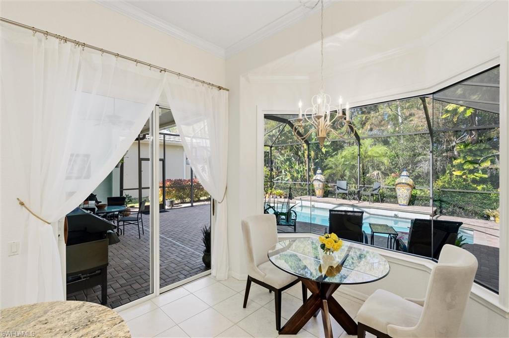 3033 Olde Cove Way Naples, FL 34119 - Photo 20 of 49 Breakfast area with view of pool and lanai
