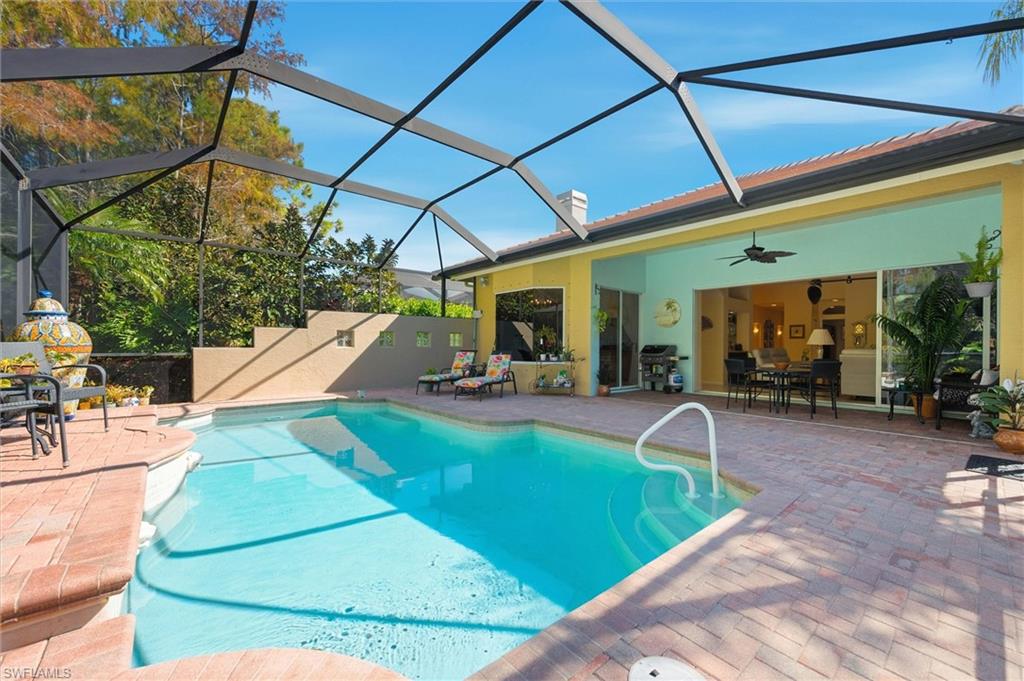 3033 Olde Cove Way Naples, FL 34119 - Photo 37 of 49 Pool with lanai enclosure