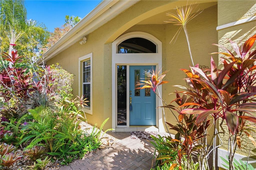3033 Olde Cove Way Naples, FL 34119 - Photo 7 of 49 Property entrance featuring stucco siding