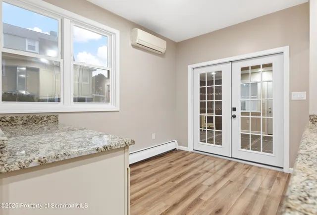 a view of an empty room with wooden floor