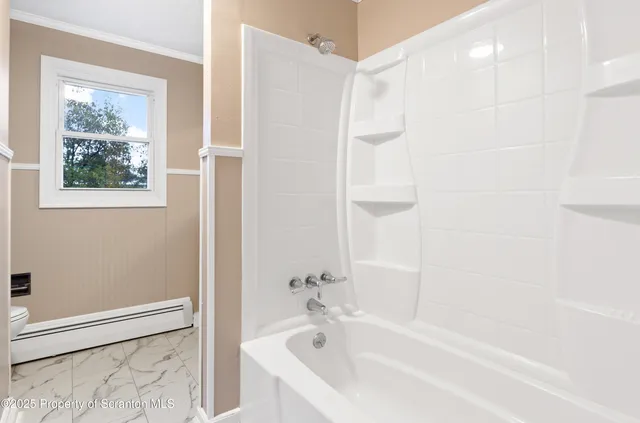 a view of a kitchen with wooden floor and a refrigerator