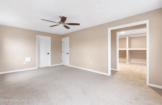 a kitchen with refrigerator and chairs
