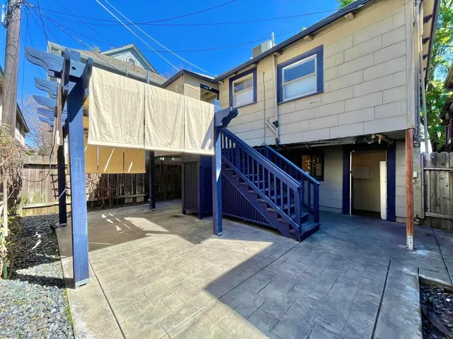 a view of a house with a balcony and stairs