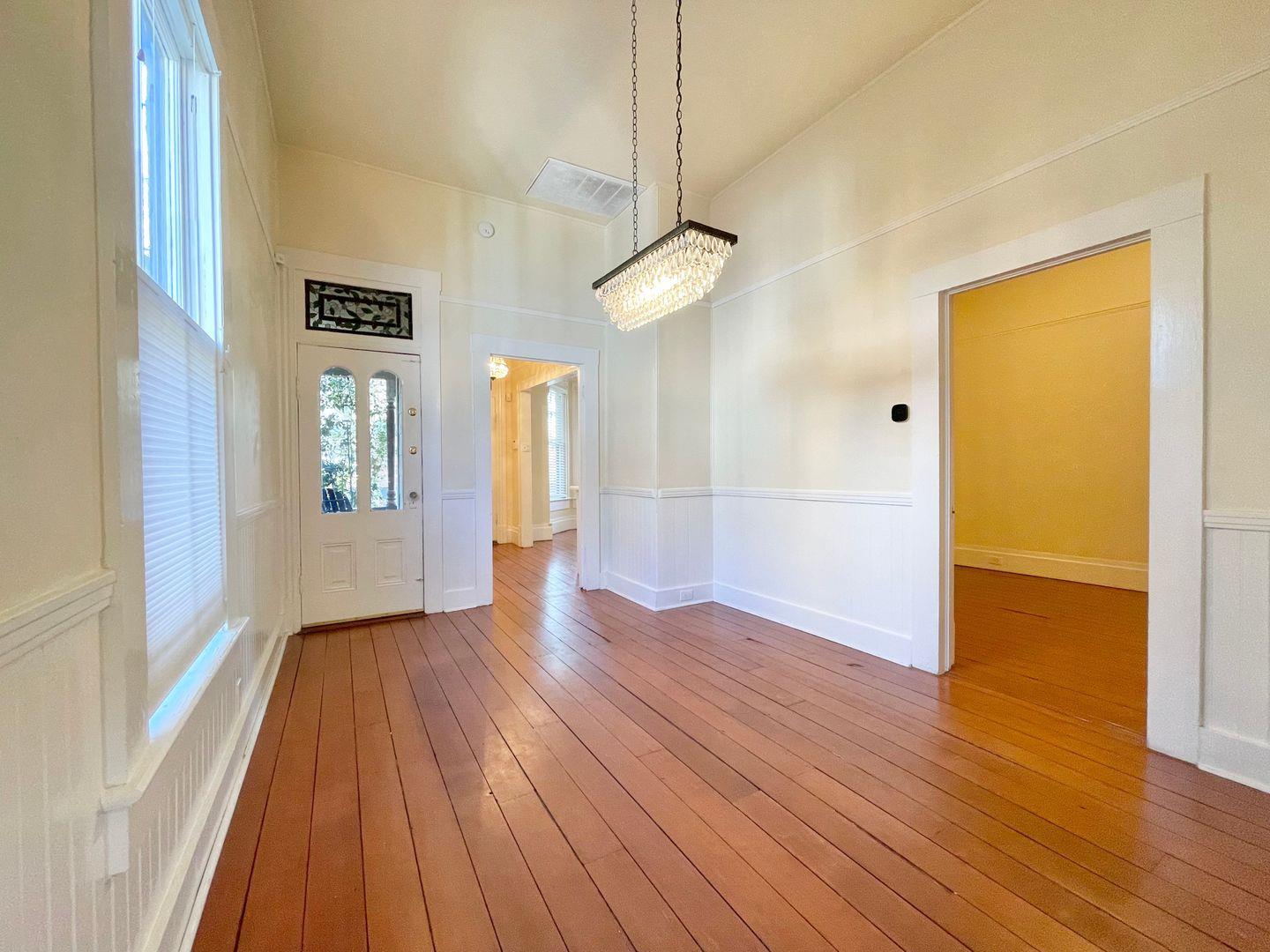 1510 19th Street Sacramento, CA 95811 - Photo 5 of 18 a view of an empty room with wooden floor and a window