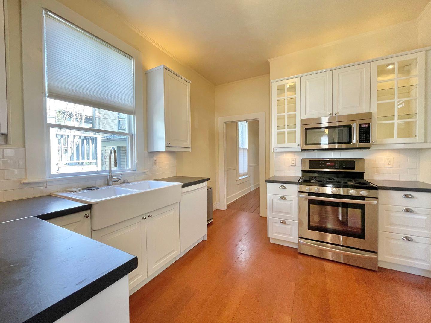 1510 19th Street Sacramento, CA 95811 - Photo 8 of 18 a kitchen with stainless steel appliances a stove a sink and a microwave