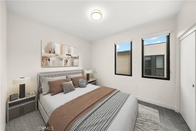 a bedroom with a bed and painting on the wall