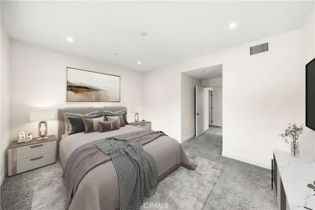 a bedroom with a bed and a painting