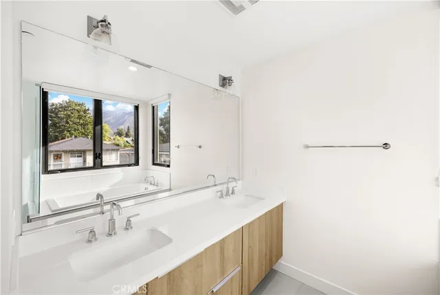 a bathroom with a sink and a large mirror