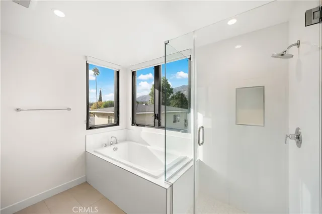 a white bath tub sitting next to a shower
