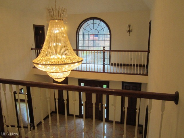 6999 Gates Road Gates Mills, OH 44040 - Photo 16 of 20 Stairs featuring a high ceiling and a chandelier