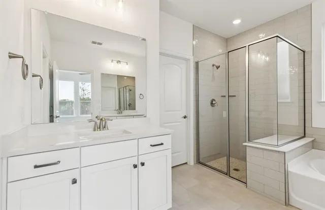 a bathroom with a shower sink and mirror