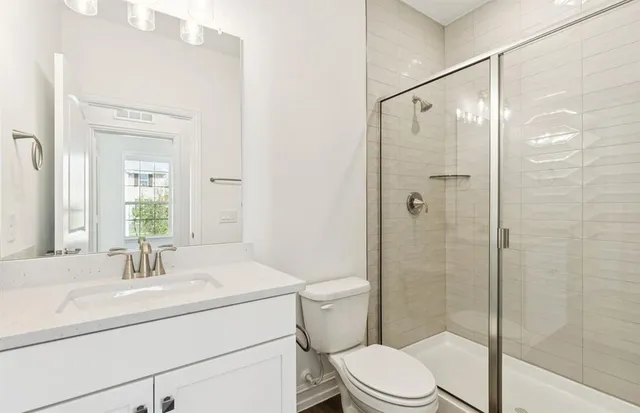 a bathroom with a sink toilet and shower